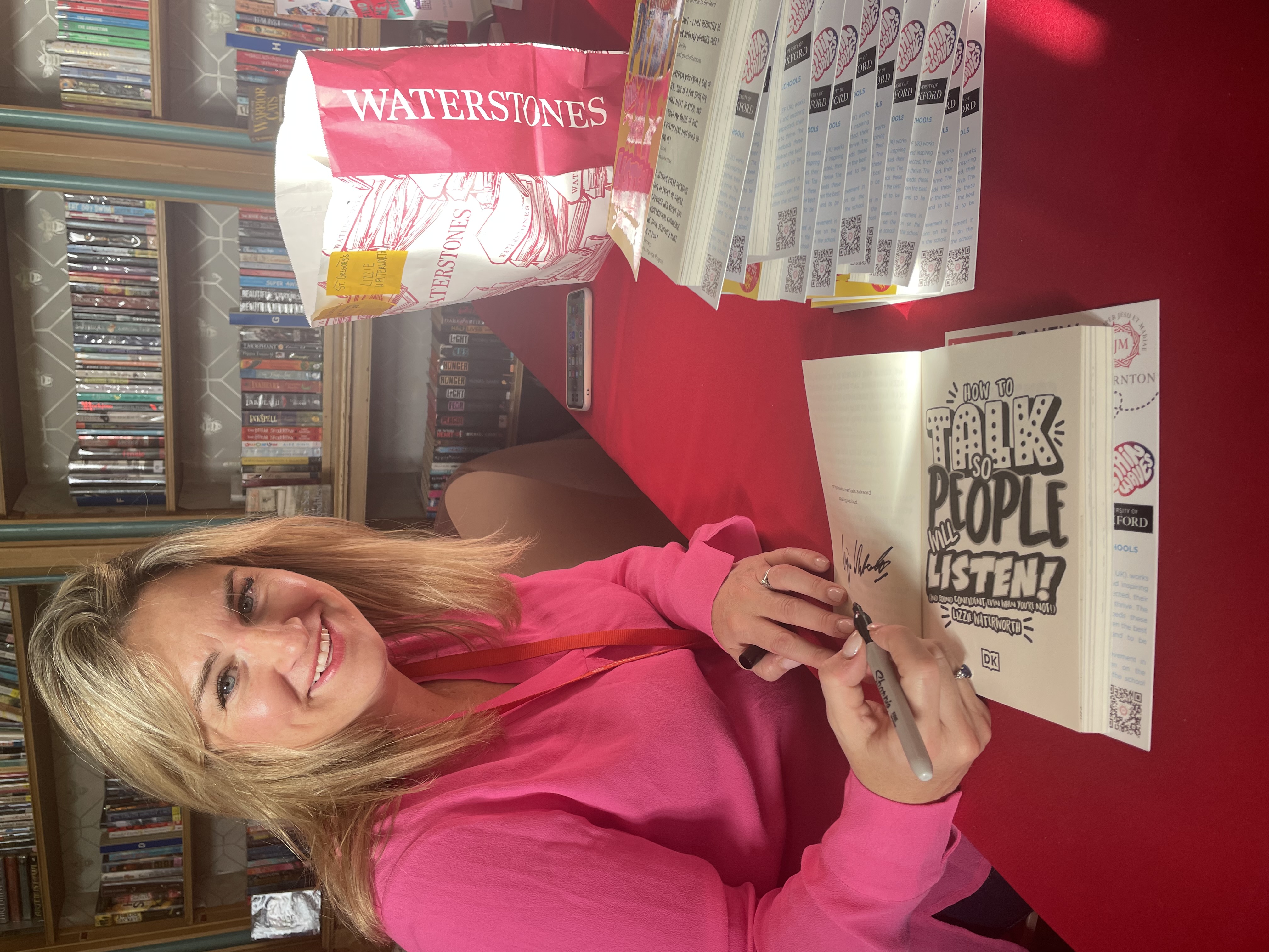 LizzieWaterworthSigningBooksinLibraryVertical2.jpeg